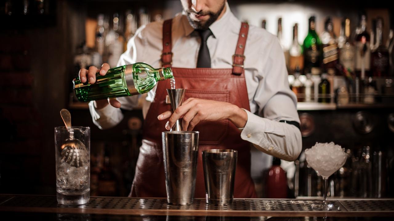 bartender-measuring-cocktail-with-jigger