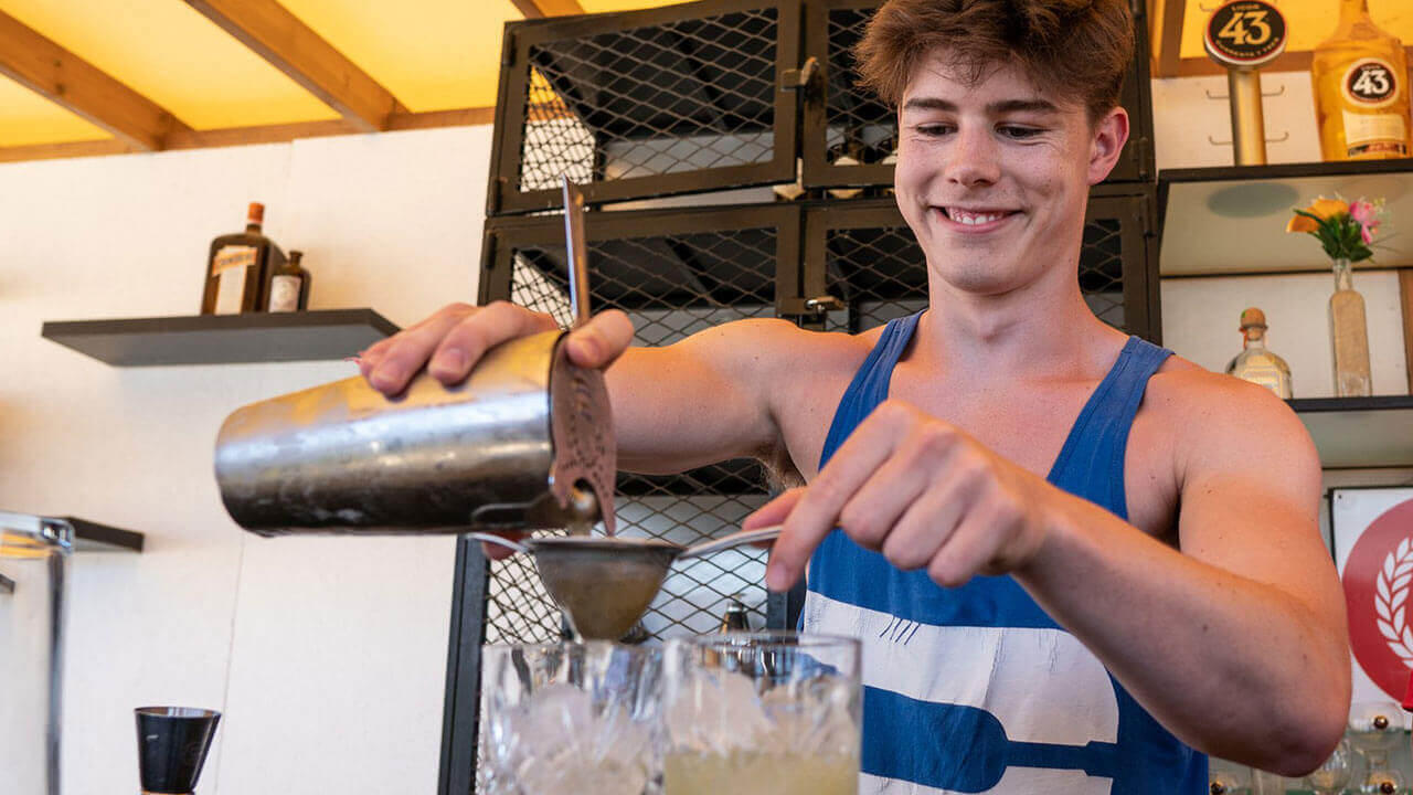 student making cocktail